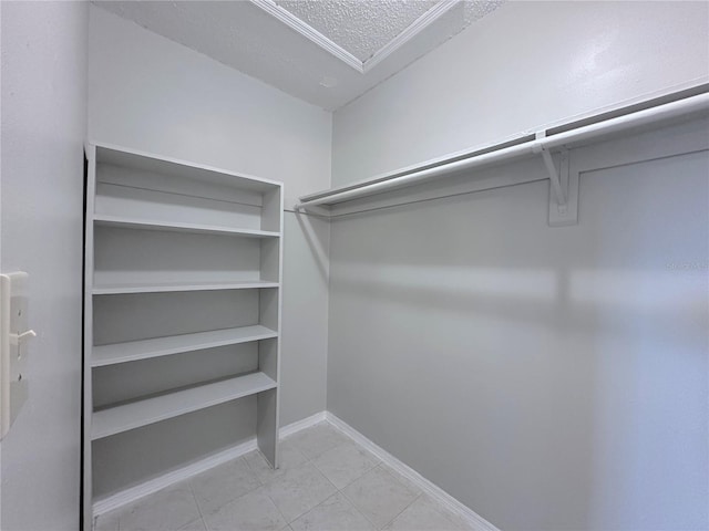 spacious closet featuring tile patterned flooring