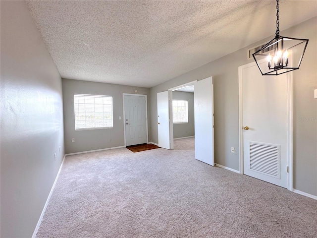 2426 Branch Way Unit 200, Maitland, FL 32751 - entryway with a chandelier, carpet flooring, and a textured ceiling