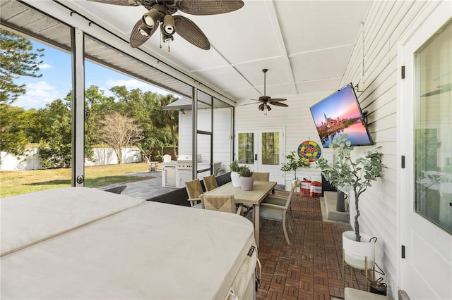 sunroom featuring ceiling fan, french doors, and outdoor dining space