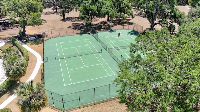 view of tennis court featuring fence
