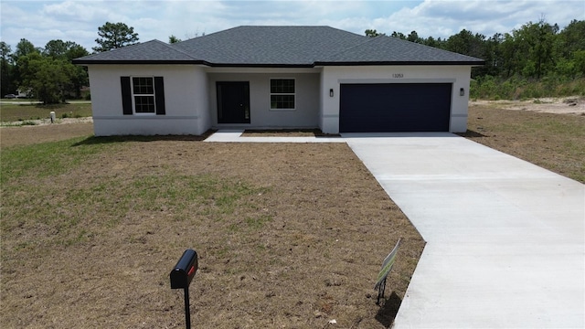 view of front of house with a shingled roof, an attached garage, driveway, and stucco siding