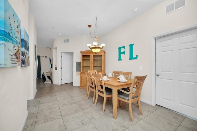 dining room with light tile patterned floors, baseboards, a notable chandelier, and visible vents