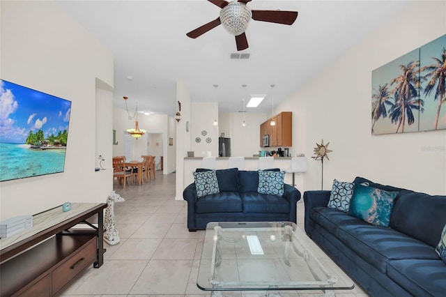 living room with visible vents, ceiling fan, and light tile patterned floors