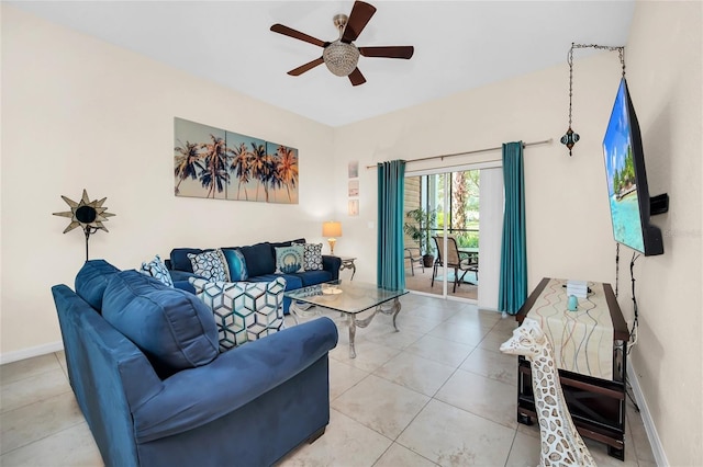 living room with light tile patterned flooring, ceiling fan, and baseboards