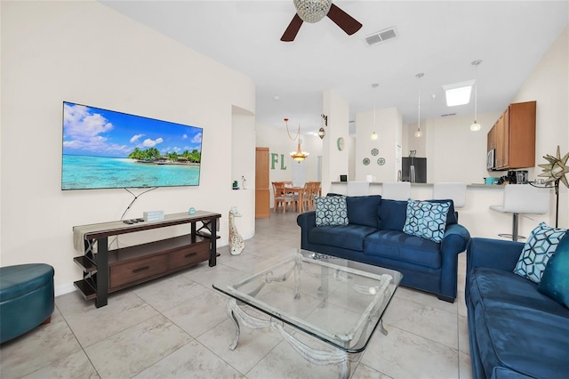 living room with ceiling fan and visible vents