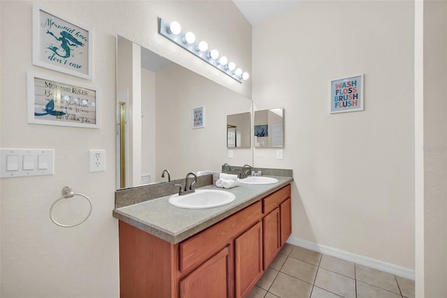 full bathroom with tile patterned flooring, a sink, baseboards, and double vanity