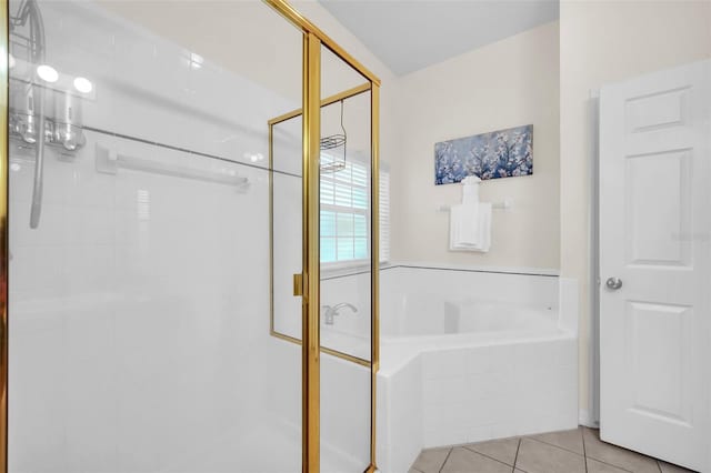 bathroom with tile patterned floors, a shower stall, and a bath