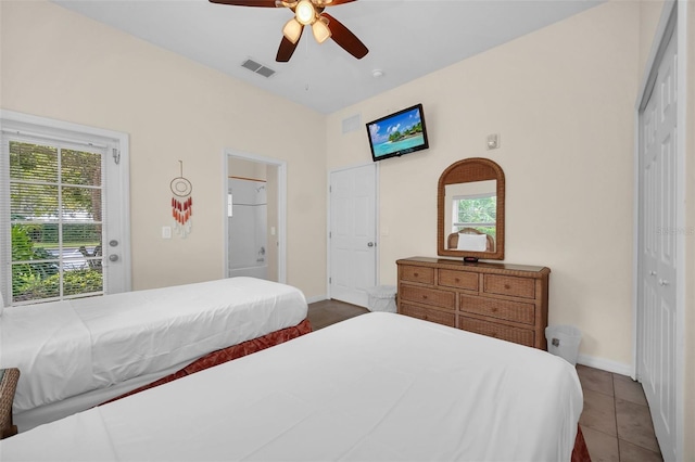 bedroom with visible vents, baseboards, tile patterned floors, and a closet