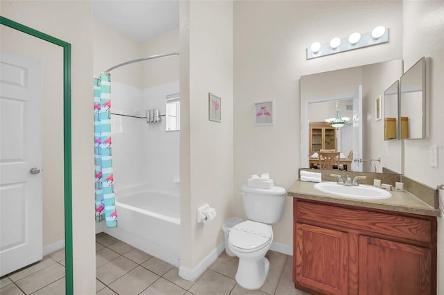 full bath with shower / bath combo, vanity, tile patterned floors, baseboards, and toilet