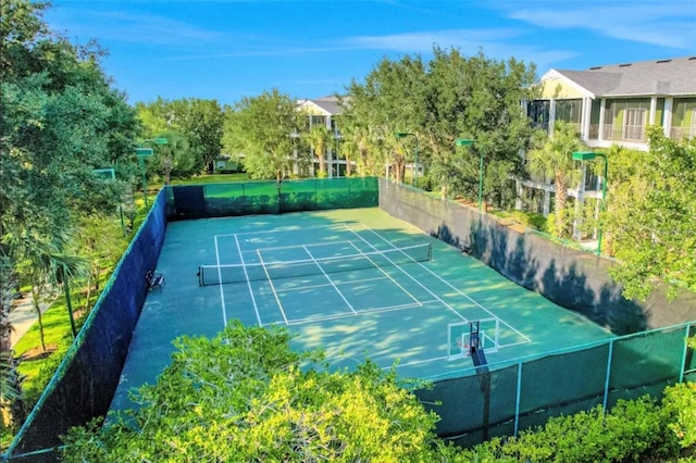 view of sport court featuring fence