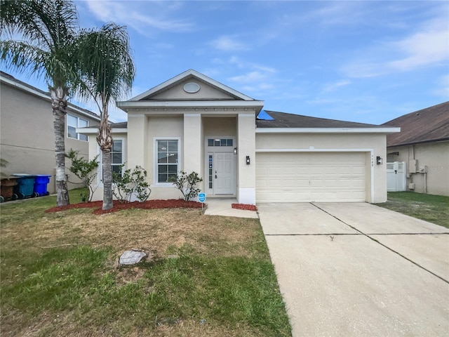 view of front of house with stucco siding, an attached garage, driveway, and a front lawn