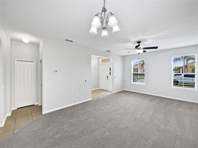 unfurnished living room with visible vents, baseboards, carpet, and tile patterned floors