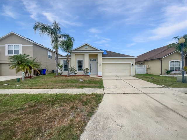 ranch-style home with stucco siding, an attached garage, driveway, and a front yard
