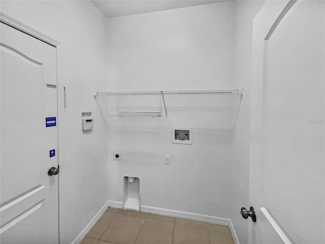 laundry room with laundry area, baseboards, hookup for a washing machine, electric dryer hookup, and light tile patterned floors