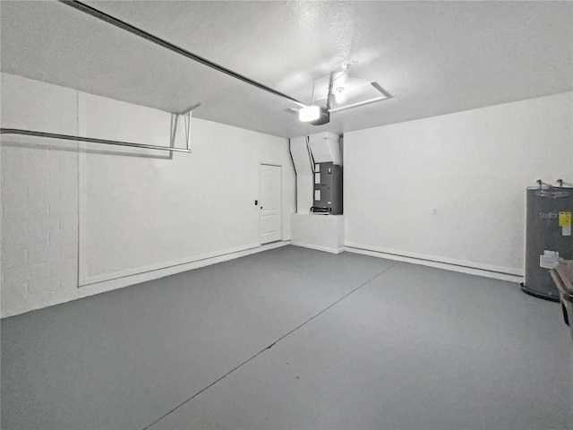 garage featuring a garage door opener, heating unit, and water heater