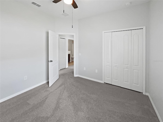 unfurnished bedroom with visible vents, a closet, baseboards, a ceiling fan, and carpet