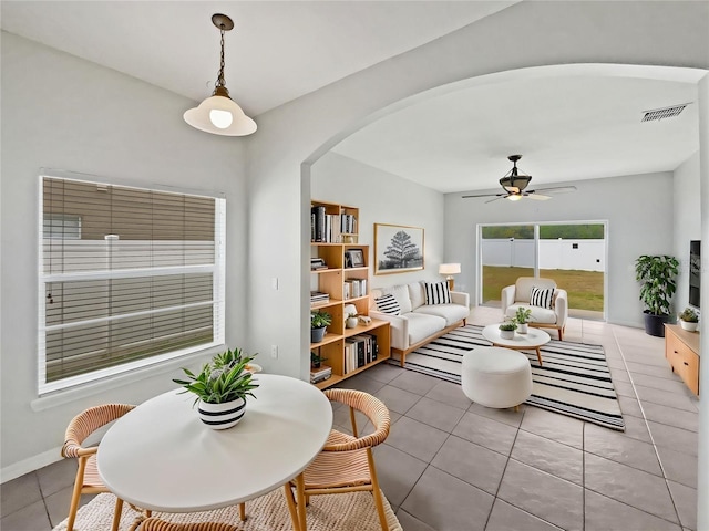 1123 Hacienda Cir, Kissimmee, FL 34741 - dining room with light tile patterned flooring, visible vents, arched walkways, a ceiling fan, and baseboards