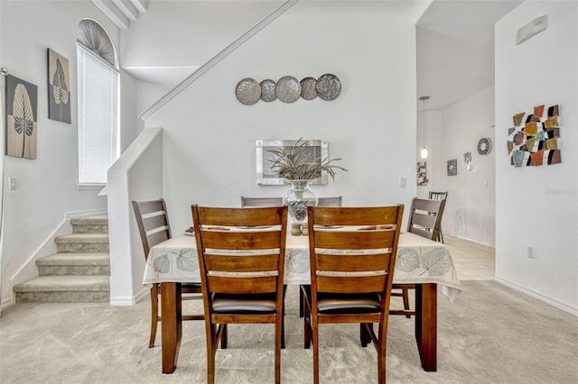 344 Cadiz Loop, Davenport, FL 33837 - dining room with stairs, carpet flooring, and baseboards