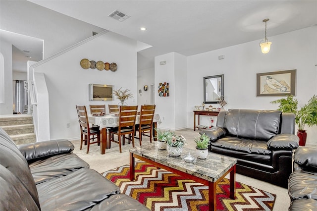 344 Cadiz Loop, Davenport, FL 33837 - living room with light colored carpet, stairs, and baseboards