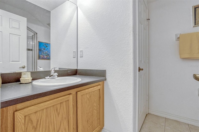 344 Cadiz Loop, Davenport, FL 33837 - bathroom with tile patterned floors, vanity, a textured wall, and baseboards