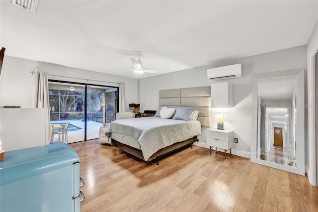 311 Needles Trl, Longwood, FL 32779 - bedroom featuring a wall unit AC, access to outside, light wood finished floors, and a ceiling fan