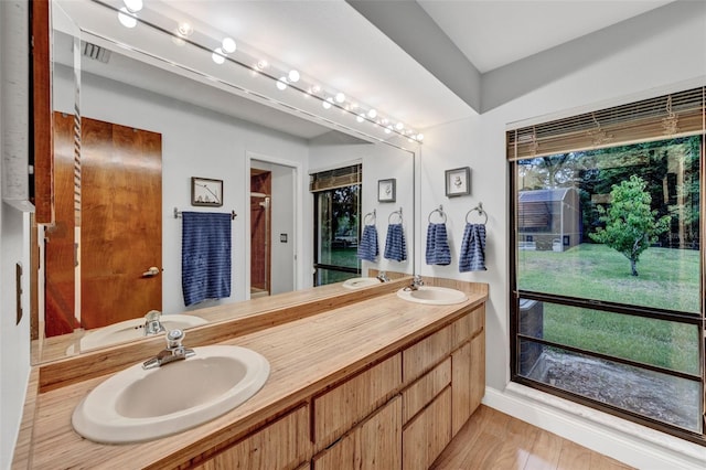 311 Needles Trl, Longwood, FL 32779 - full bath featuring wood finished floors, double vanity, and a shower