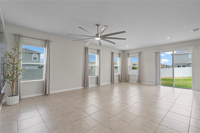spare room featuring ceiling fan, recessed lighting, baseboards, light tile patterned floors, and visible vents