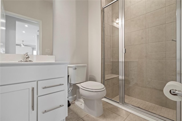 full bath with ceiling fan, a stall shower, vanity, tile patterned floors, and toilet