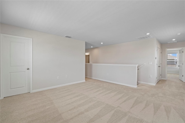 empty room with carpet flooring, recessed lighting, baseboards, and visible vents