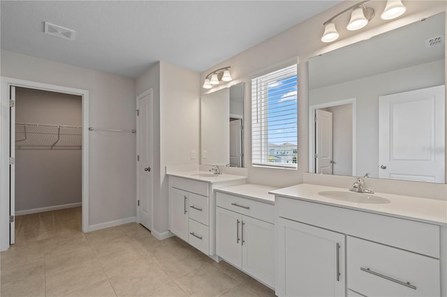 full bath with visible vents, tile patterned flooring, a spacious closet, and vanity