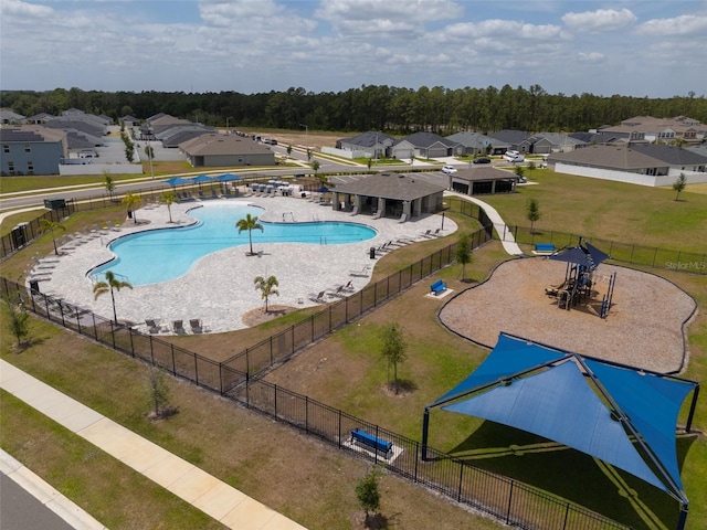 community pool featuring fence and a residential view