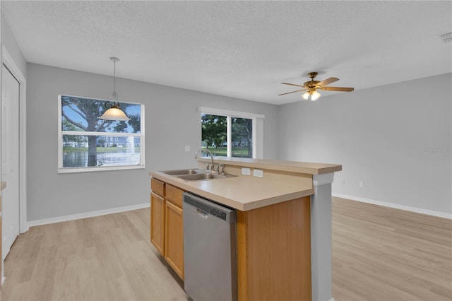 kitchen with stainless steel dishwasher, a sink, light wood-style flooring, a textured ceiling, and ceiling fan