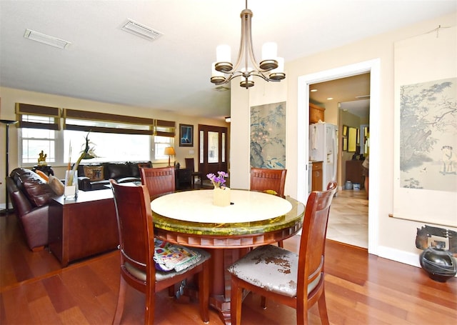 2900 Cullen Lake Shore Dr, Belle Isle, FL 32812 - dining room with wood finished floors, a chandelier, and baseboards