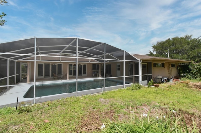 2900 Cullen Lake Shore Dr, Belle Isle, FL 32812 - back of property with a lawn, an outdoor pool, a patio area, and glass enclosure