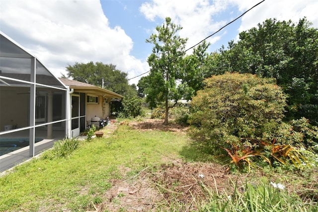 2900 Cullen Lake Shore Dr, Belle Isle, FL 32812 - view of green lawn with glass enclosure and an outdoor pool