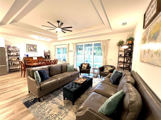 6709 SW 15th Pl, Gainesville, FL 32607 - living area with a tray ceiling, visible vents, light wood finished floors, and a ceiling fan