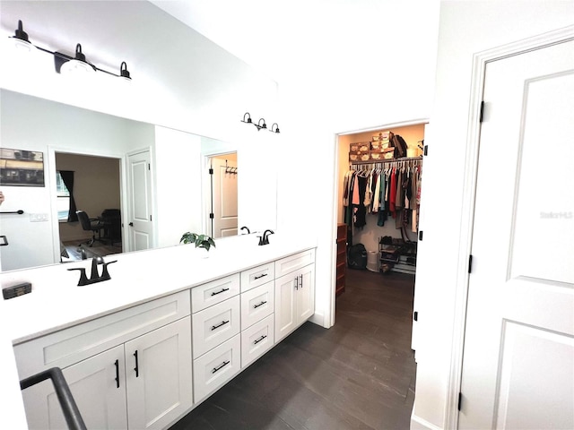 6709 SW 15th Pl, Gainesville, FL 32607 - full bathroom with wood finished floors, double vanity, and a walk in closet