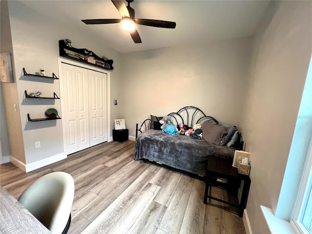 6709 SW 15th Pl, Gainesville, FL 32607 - bedroom with wood finished floors, a closet, baseboards, and ceiling fan