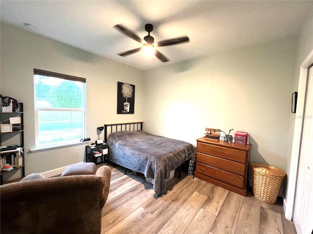 6709 SW 15th Pl, Gainesville, FL 32607 - bedroom featuring light wood-type flooring, ceiling fan, and baseboards
