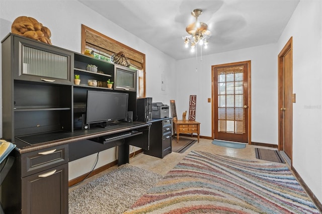home office with a ceiling fan and baseboards