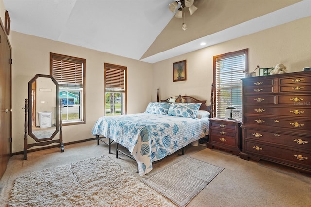 bedroom featuring baseboards, multiple windows, vaulted ceiling, and light colored carpet