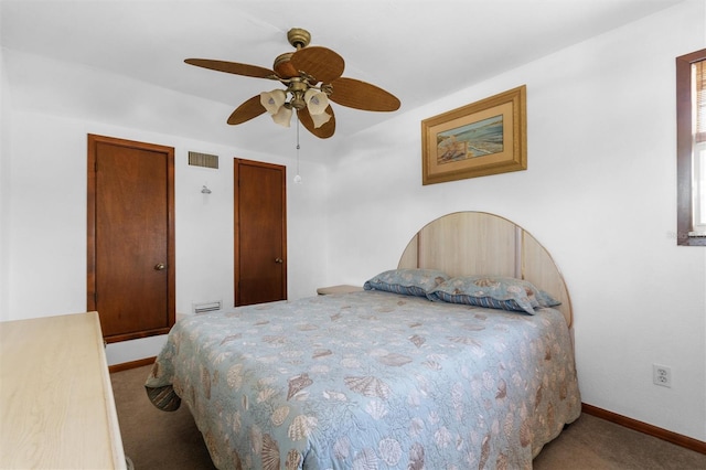 carpeted bedroom featuring visible vents, baseboards, and ceiling fan