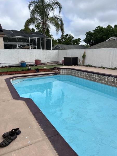 view of swimming pool with a fenced backyard and a fenced in pool