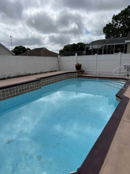 view of swimming pool with a fenced backyard and a fenced in pool