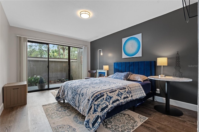 111 Crown Oaks Way Unit 101, Longwood, FL 32779 - bedroom featuring wood finished floors, access to outside, and baseboards