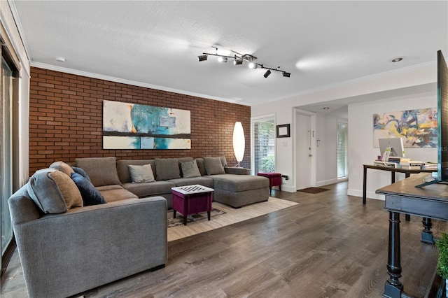 111 Crown Oaks Way Unit 101, Longwood, FL 32779 - living area featuring brick wall, wood finished floors, and baseboards