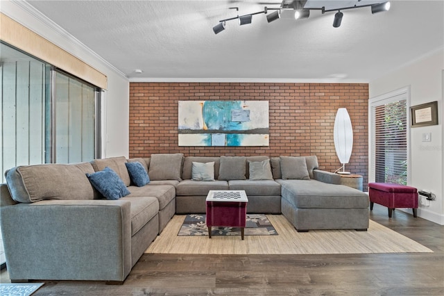 111 Crown Oaks Way Unit 101, Longwood, FL 32779 - living room with brick wall, wood finished floors, crown molding, and a textured ceiling