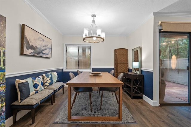 111 Crown Oaks Way Unit 101, Longwood, FL 32779 - dining space featuring wood finished floors, a chandelier, ornamental molding, wainscoting, and baseboards