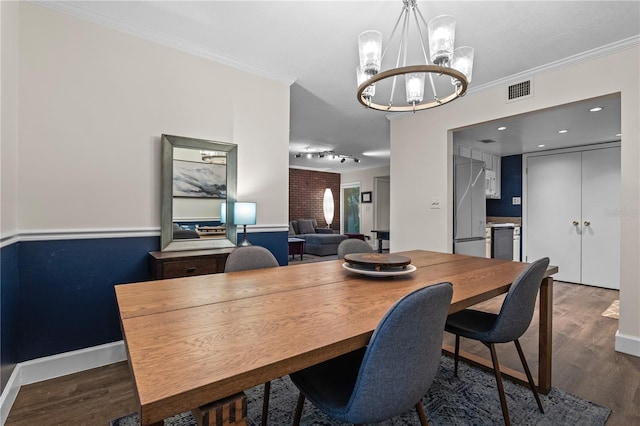 111 Crown Oaks Way Unit 101, Longwood, FL 32779 - dining area with a chandelier, dark wood-style floors, ornamental molding, and baseboards