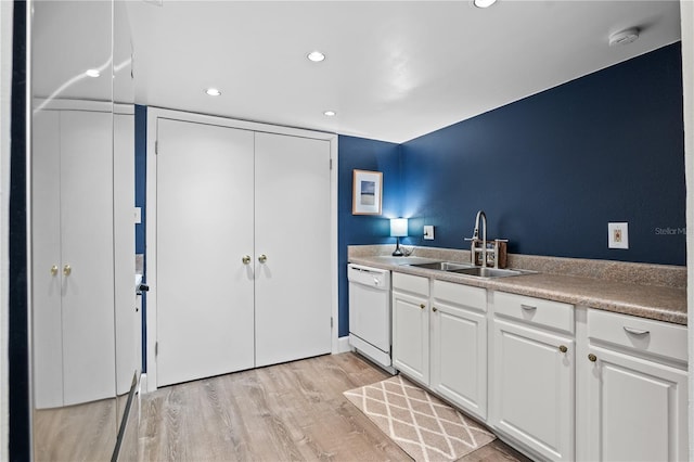 111 Crown Oaks Way Unit 101, Longwood, FL 32779 - kitchen featuring white dishwasher, a sink, light wood-style floors, white cabinets, and recessed lighting